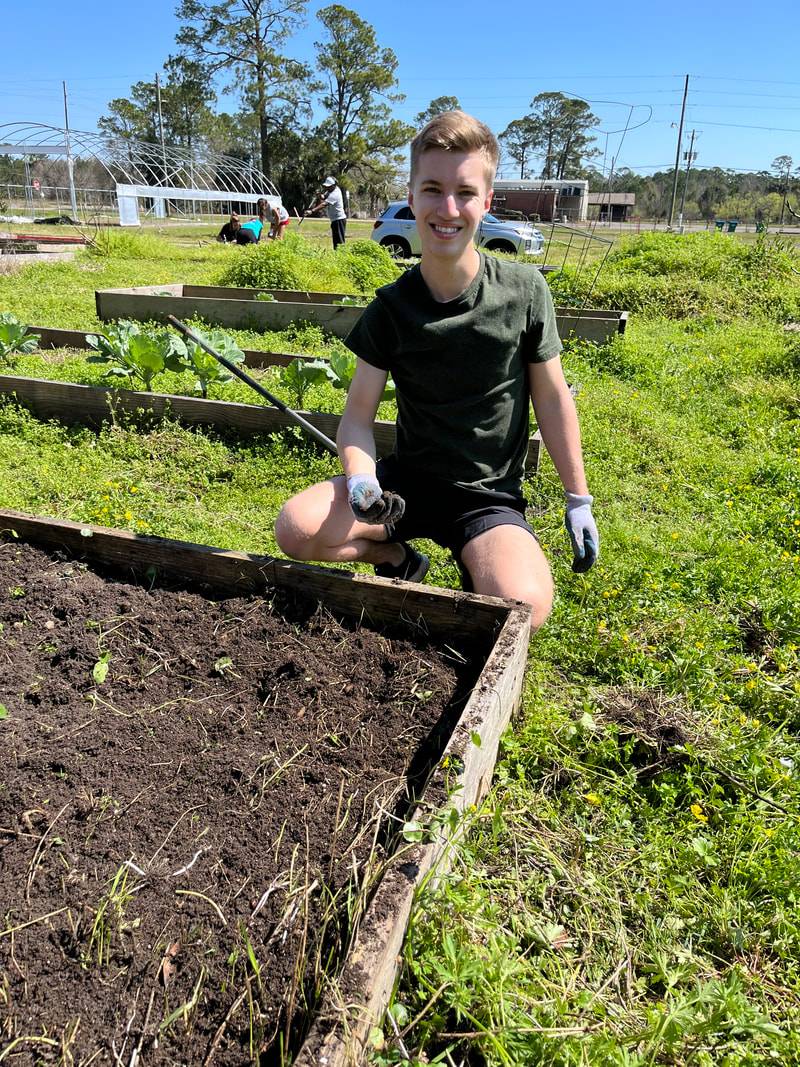 Student helping out at a community garden